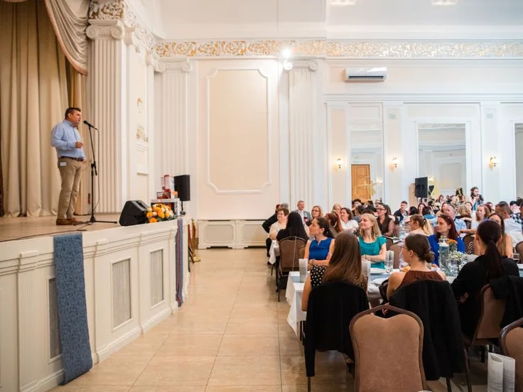 a man speaking in front of a crowd